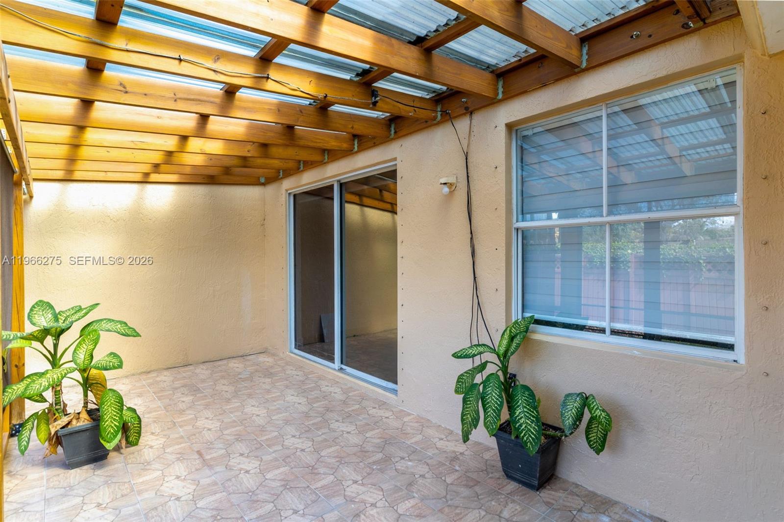 30 Southeast 6th Road Homestead, FL 33030 - Photo 26 of 34 a view of a porch with a potted plant