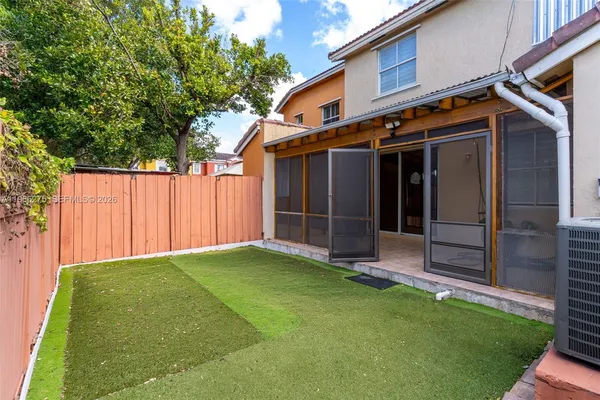 a view of backyard of house with green space