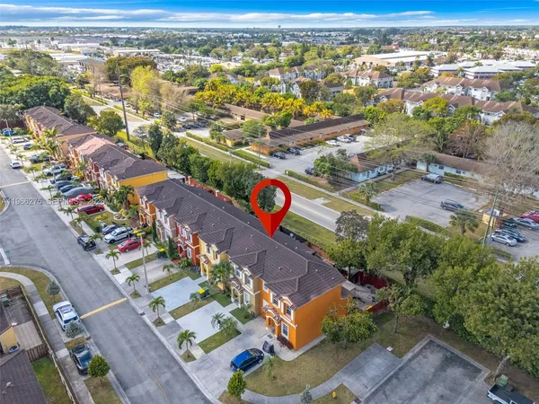 an aerial view of residential houses with outdoor space