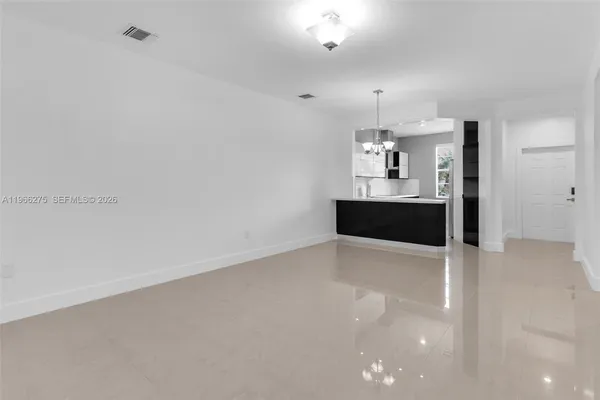 a view of kitchen and empty room