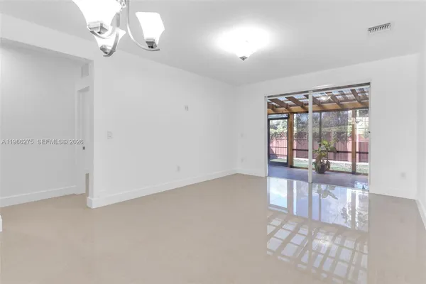 an empty room with windows and outdoor view