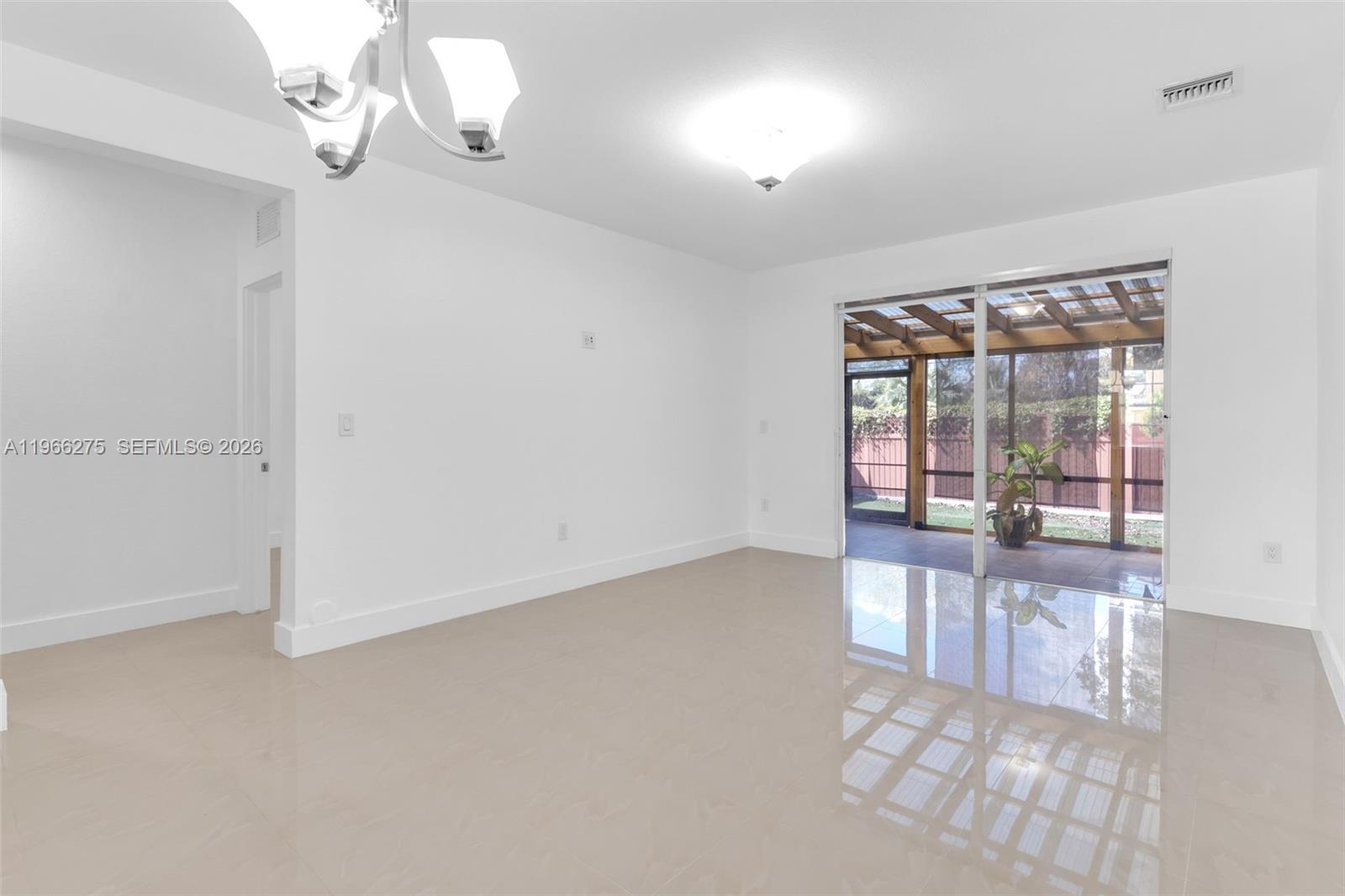 30 Southeast 6th Road Homestead, FL 33030 - Photo 10 of 34 an empty room with windows and outdoor view