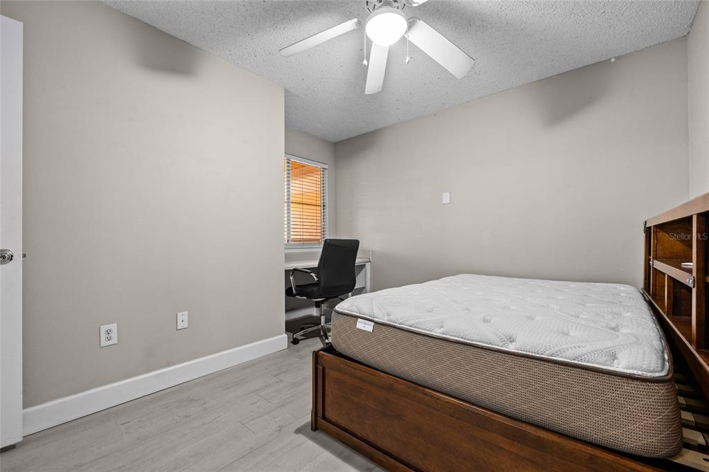 2601 Southwest Archer Road, Unit 334 Gainesville, FL 32608 - Photo 17 of 31 a room with a bed and a chandelier