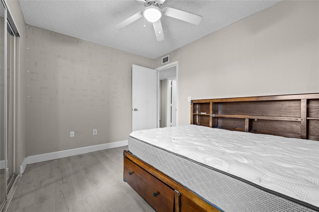 2601 Southwest Archer Road, Unit 334 Gainesville, FL 32608 - Photo 18 of 31 a bedroom with a bed and a chandelier