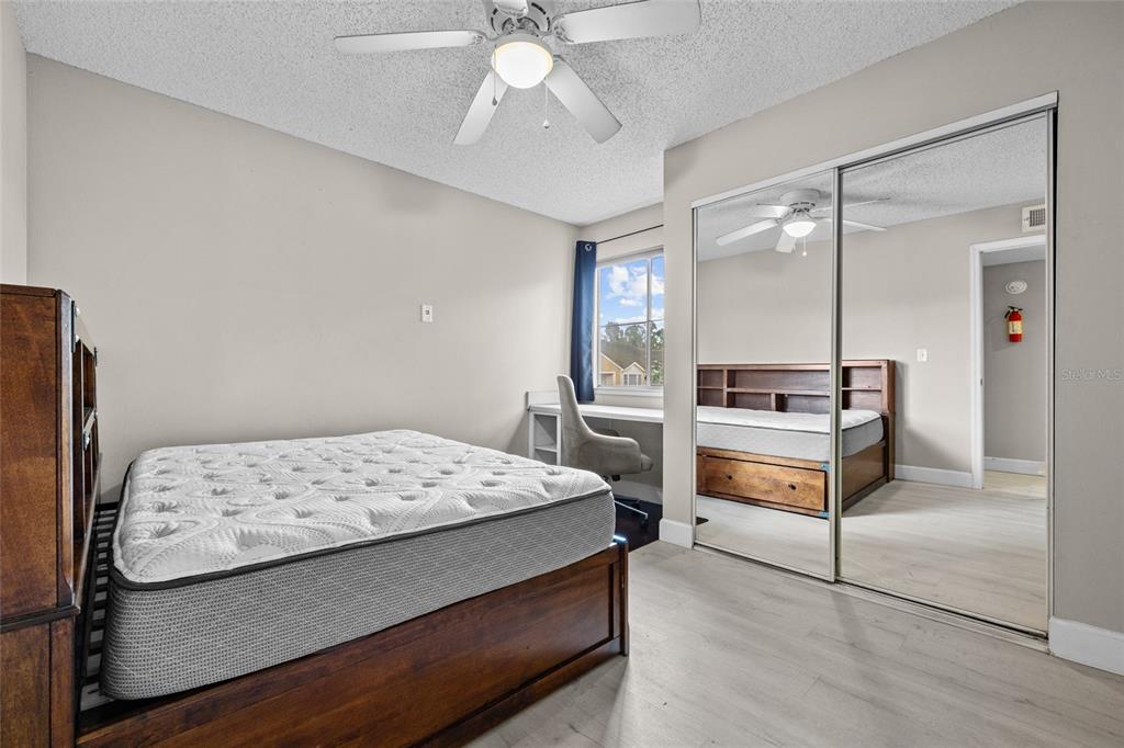 2601 Southwest Archer Road, Unit 334 Gainesville, FL 32608 - Photo 21 of 31 a bedroom with a bed and a chandelier