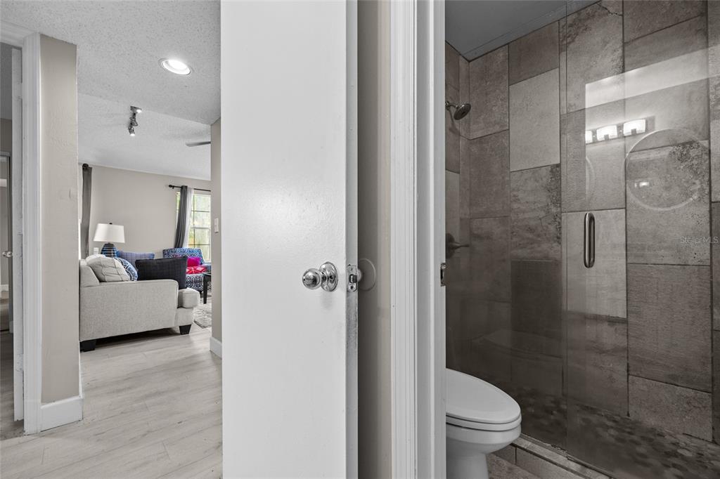 2601 Southwest Archer Road, Unit 334 Gainesville, FL 32608 - Photo 22 of 31 a bathroom with a toilet and a shower