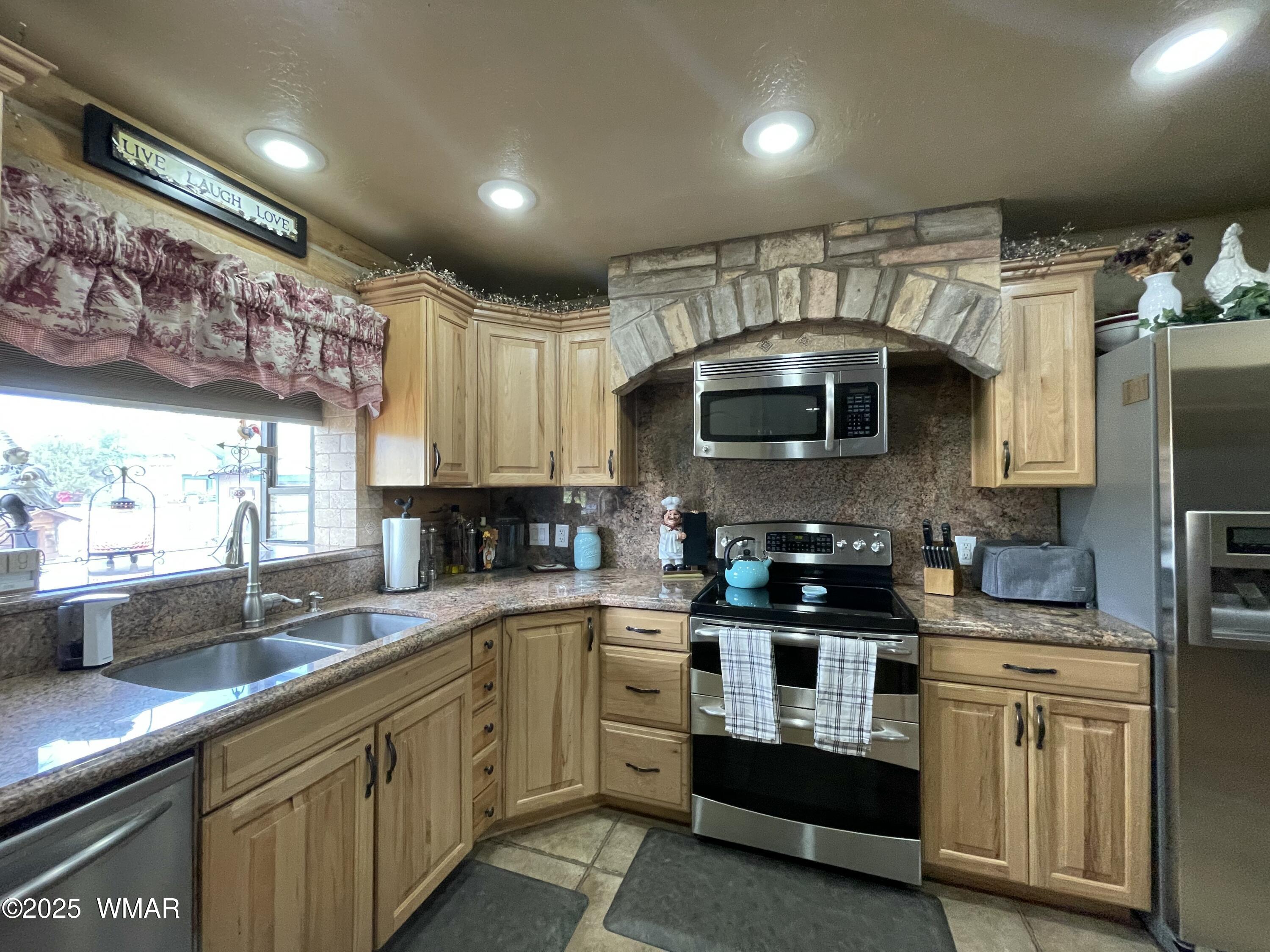183 North Becker Lake Road Springerville, AZ 85938 - Photo 13 of 41 a kitchen with stainless steel appliances granite countertop a sink a stove and a microwave