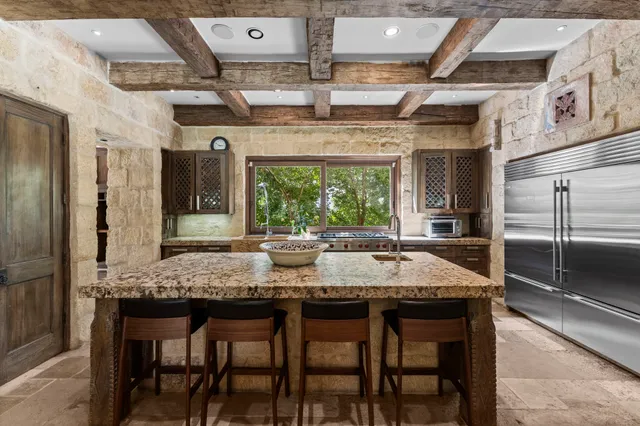 a kitchen with a counter space and a refrigerator