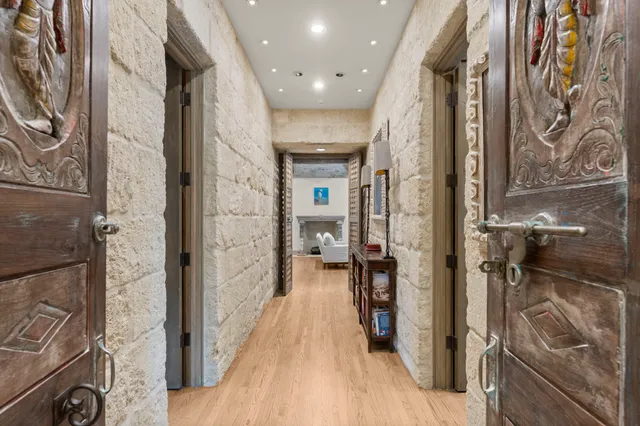 a view of a hallway with a livingroom view and furniture