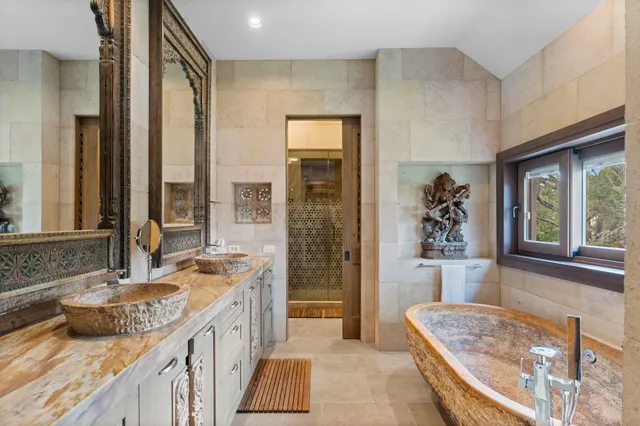 a spacious bathroom with sink shower and bathtub