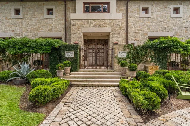 a front view of a house with plants