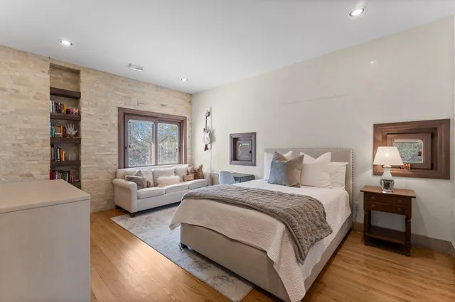 a spacious bedroom with a bed and a couch