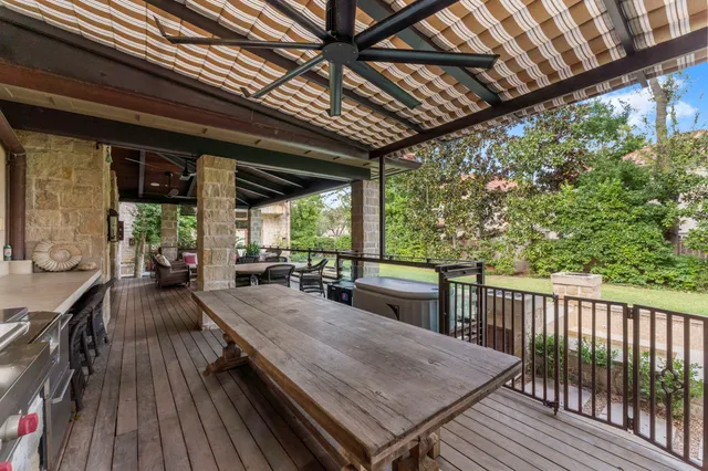 a view of a patio with table and chairs with wooden floor and fence