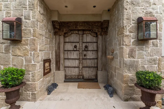 a view of front door and potted plants