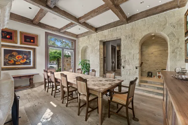 a view of a dining room with furniture a chandelier and wooden floor