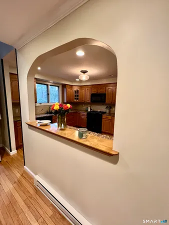 a kitchen with granite countertop wooden floors a sink and a stove