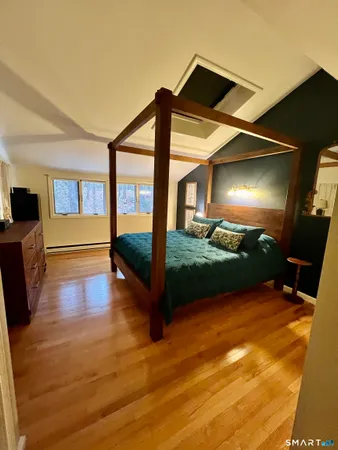 a bedroom with a bed and large window
