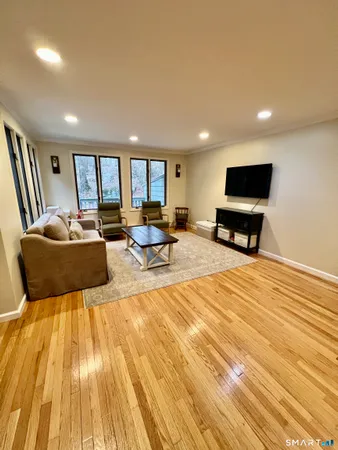 a living room with a couch and a wooden floor