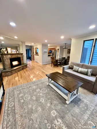 a living room with furniture and a wooden floor