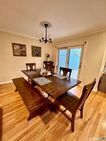 a living room with a table chairs and a wooden floor