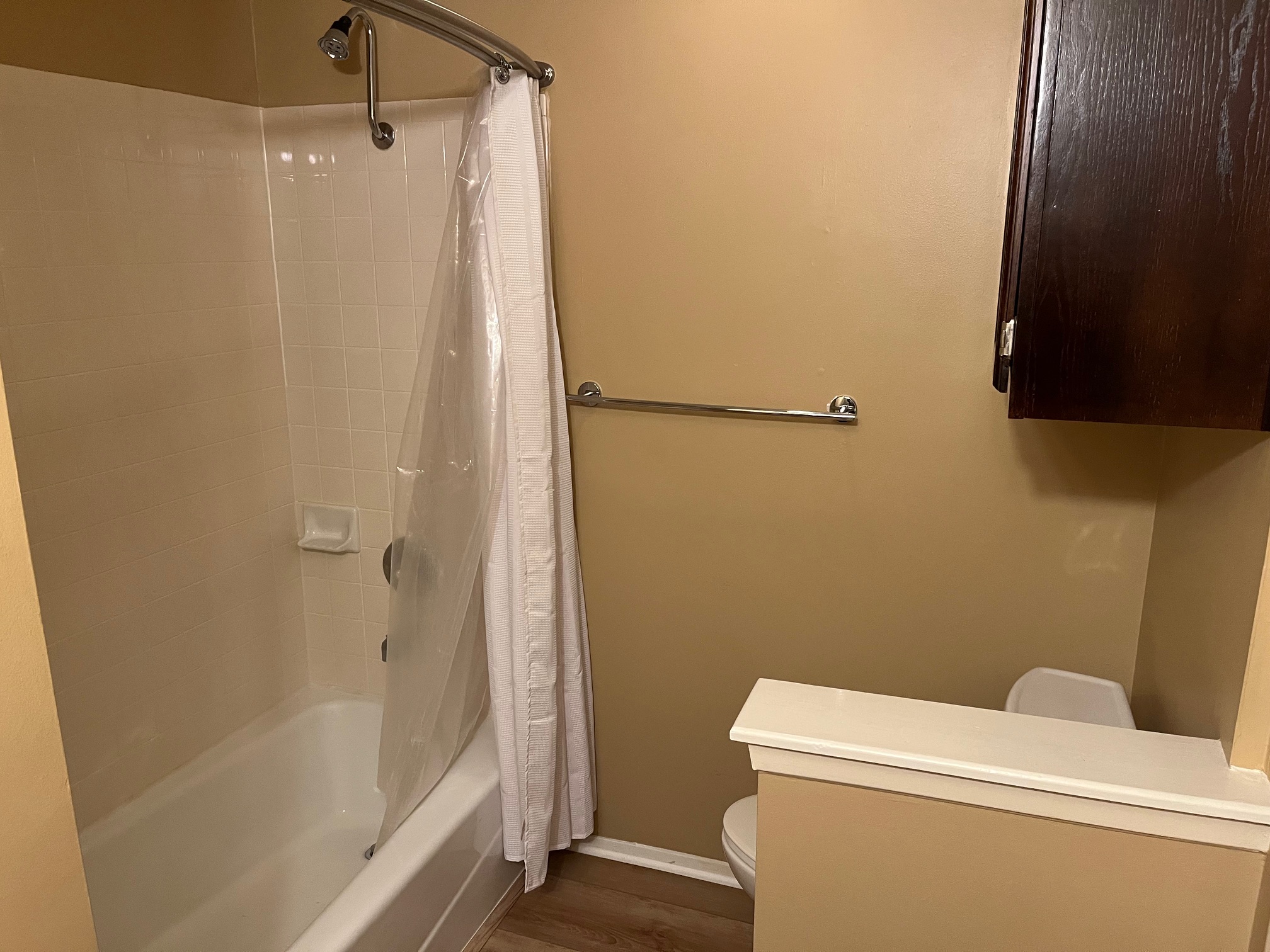 12919 Marimba Trail Austin, TX 78729 - Photo 15 of 20 Bathroom featuring shower / bath combo with shower curtain, vanity, and dark wood finished floors