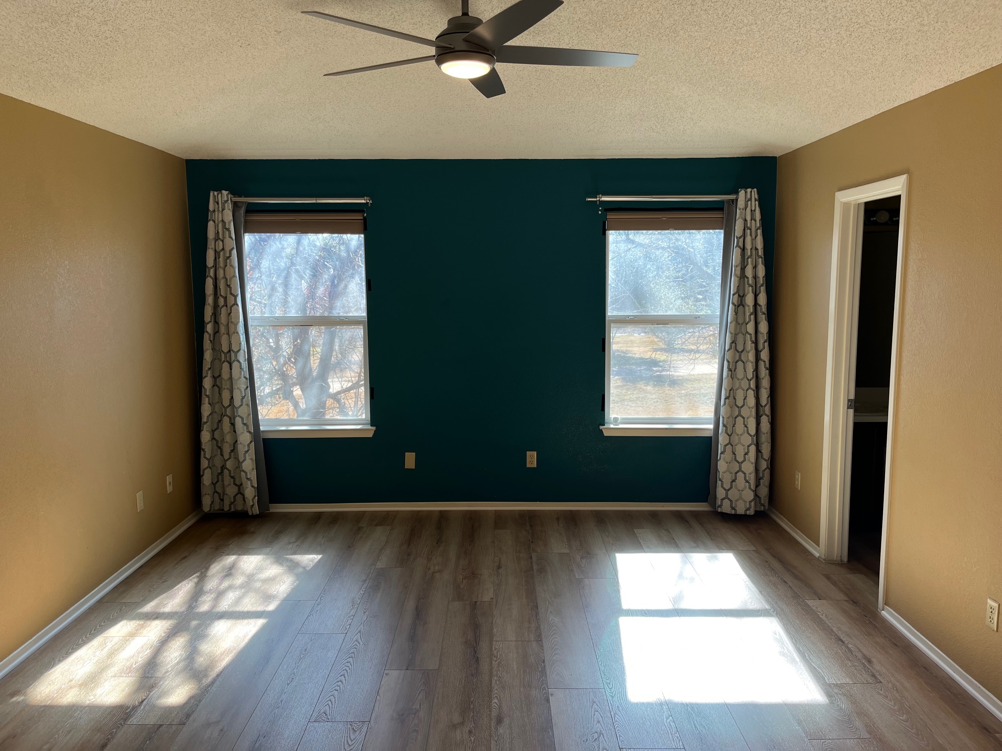 12919 Marimba Trail Austin, TX 78729 - Photo 17 of 20 Unfurnished bedroom with wood finished floors, a ceiling fan, and a textured ceiling