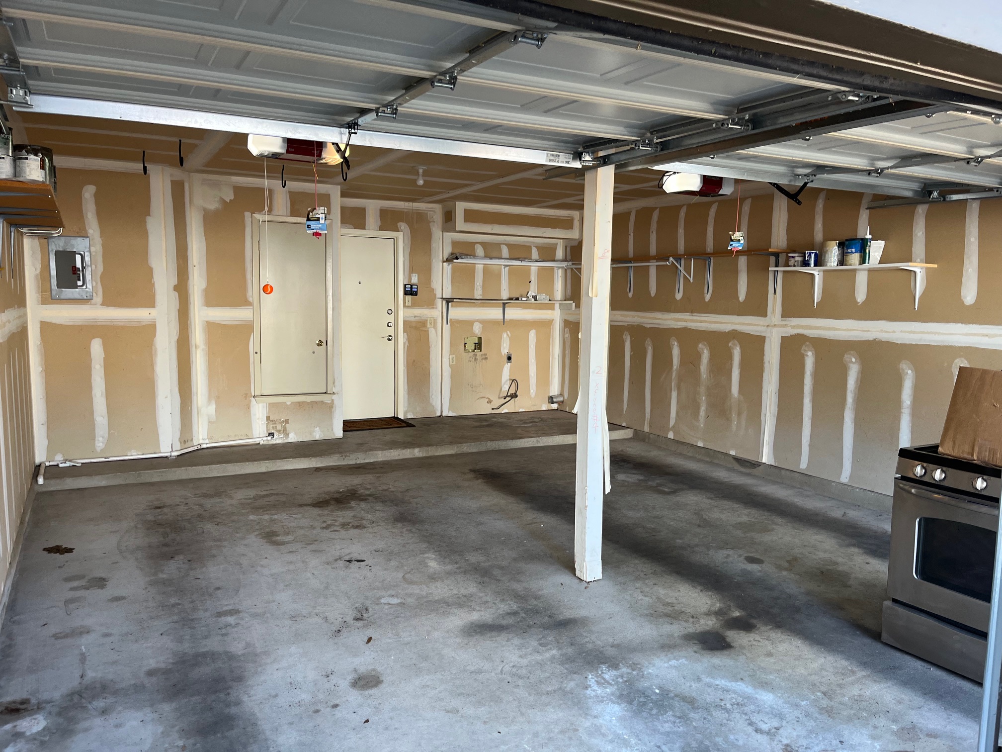 12919 Marimba Trail Austin, TX 78729 - Photo 18 of 20 Garage featuring electric panel and a garage door opener