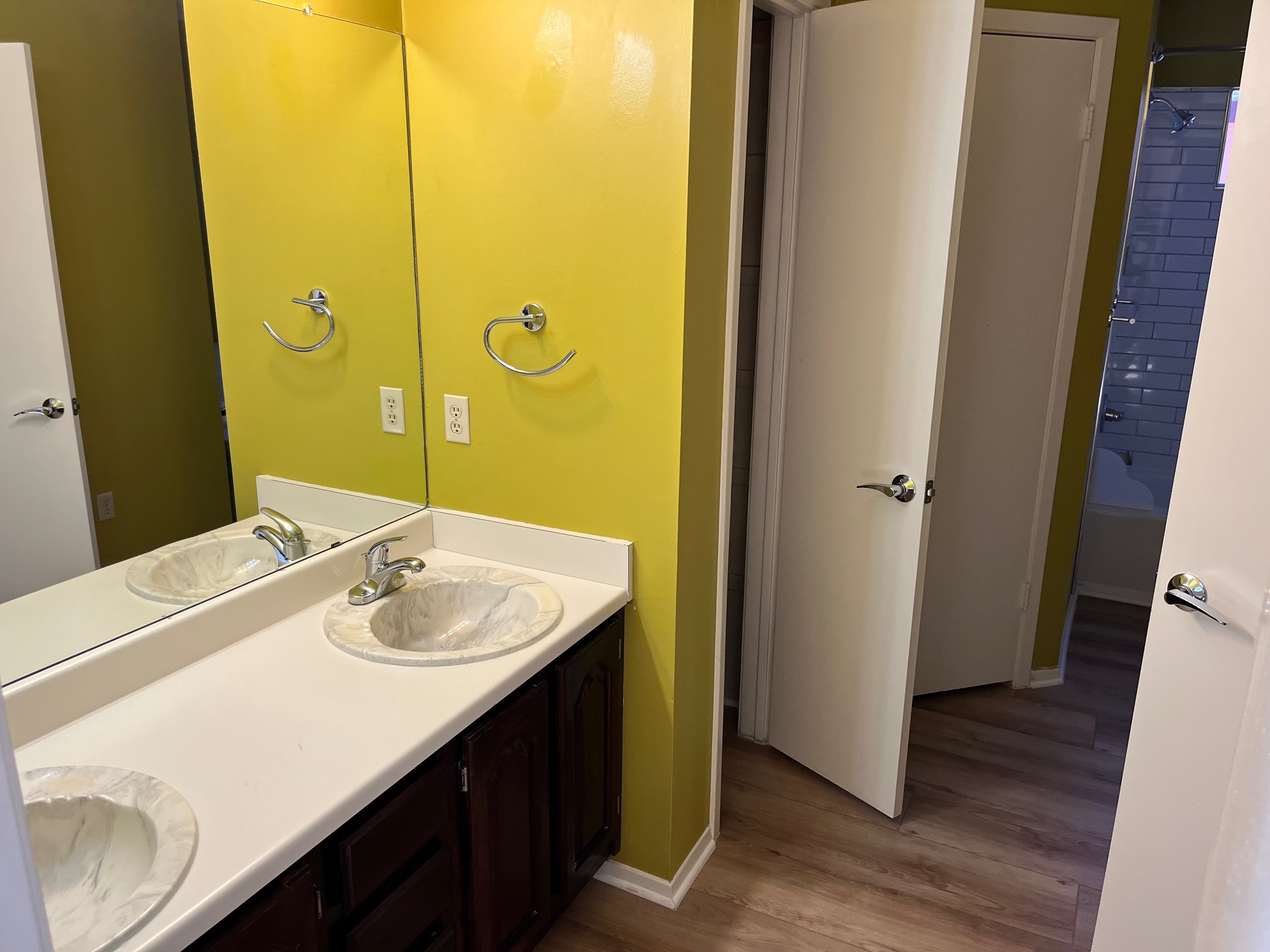 12919 Marimba Trail Austin, TX 78729 - Photo 19 of 20 Bathroom featuring double vanity, bathing tub / shower combination, and dark wood finished floors