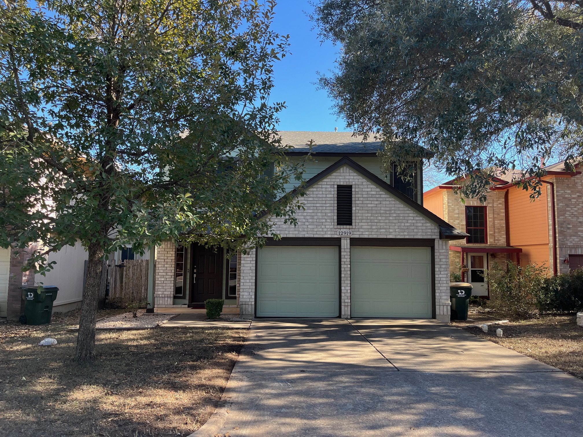 12919 Marimba Trail Austin, TX 78729 - Photo 2 of 20 View of front facade with concrete driveway, an attached garage, and brick siding