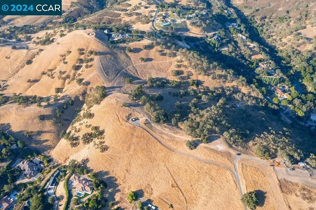 an aerial view of residential house with green space