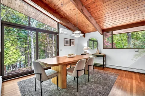 a dining room with furniture and window
