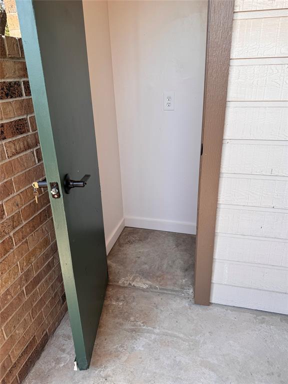 2305 Basil Drive, Unit D108 Arlington, TX 76006 - Photo 15 of 23 Bathroom featuring concrete flooring and brick wall
