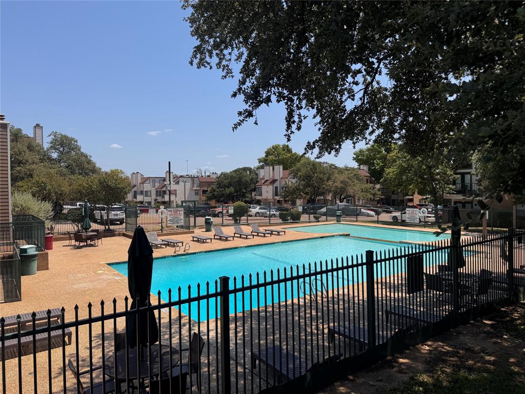 2305 Basil Drive, Unit D108 Arlington, TX 76006 - Photo 18 of 23 Community pool featuring a patio and a residential view