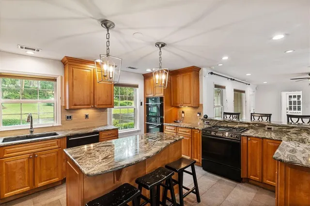 a kitchen with stainless steel appliances a sink stove and refrigerator