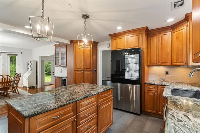a view of a a dining room with furniture and window