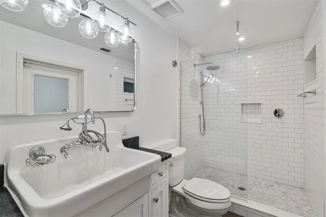 a view of a kitchen with furniture and a refrigerator