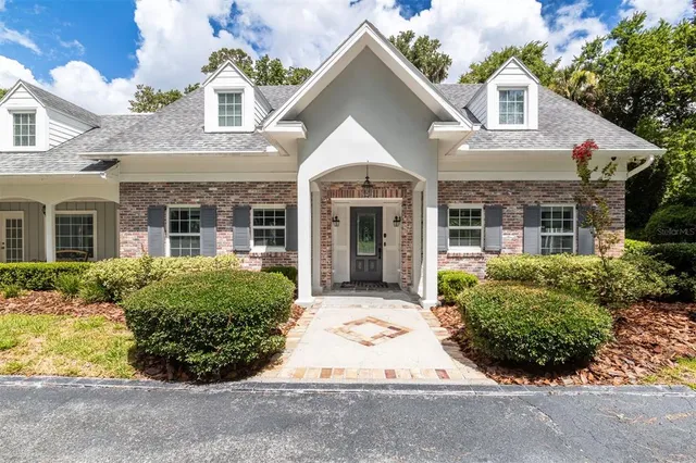 a front view of a house with garden and porch