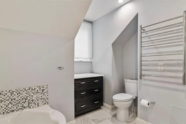 a bathroom with a granite countertop sink a mirror a bathtub and shower