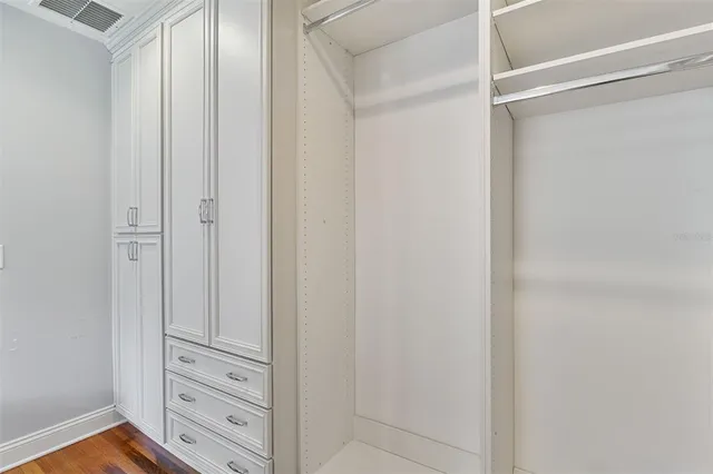 a view of a house with a big yard and large trees