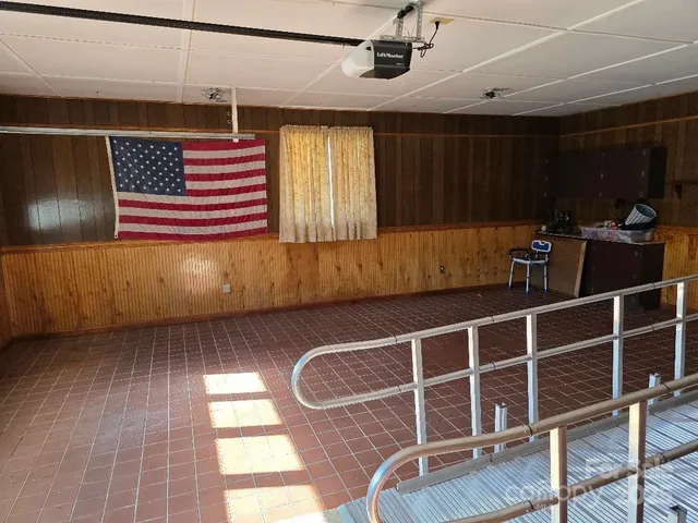a room with wooden floor and windows