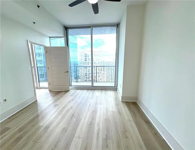 wooden floor in an empty room with a window