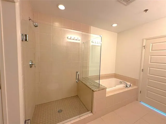 a bathroom with a tub and shower