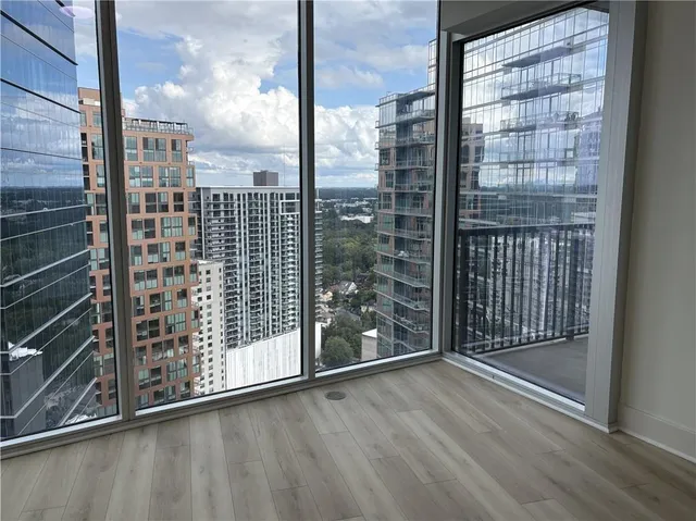 a view of a room with wooden floor