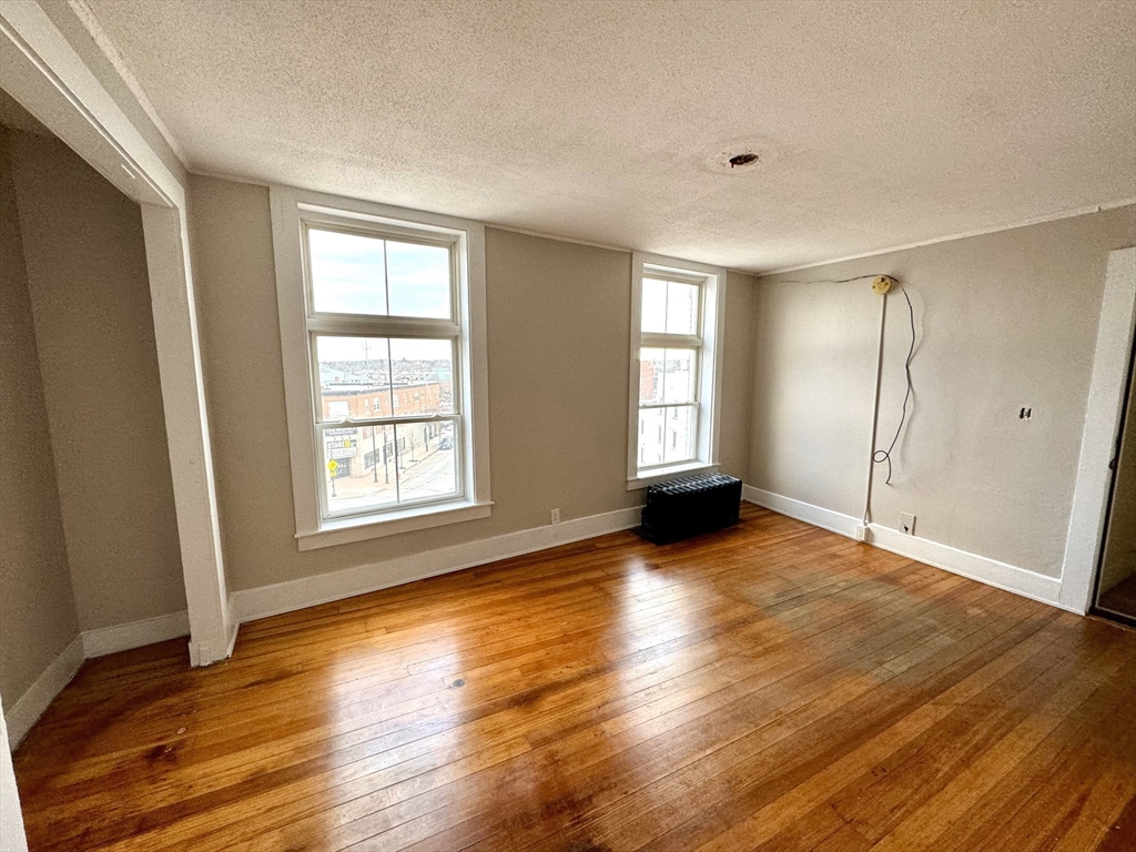 2-6 North Main Street Rochester, NH 03867 - Photo 11 of 40 an empty room with wooden floor and windows