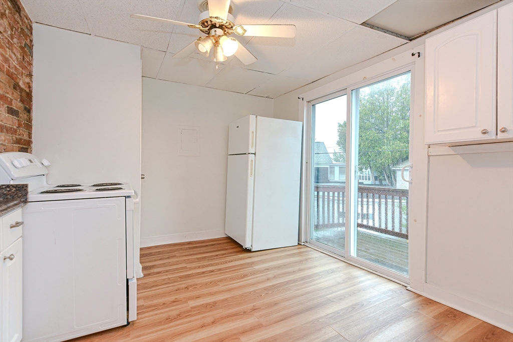 2-6 North Main Street Rochester, NH 03867 - Photo 20 of 40 a view of a livingroom with wooden floor and a ceiling fan
