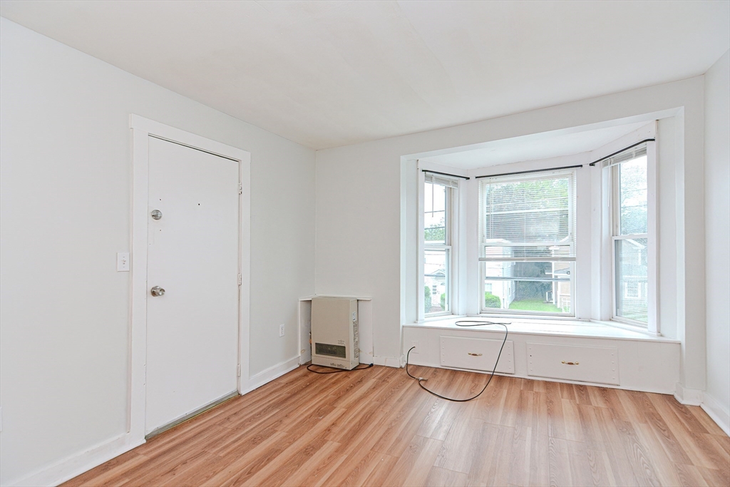 2-6 North Main Street Rochester, NH 03867 - Photo 21 of 40 a view of an empty room with wooden floor and a window