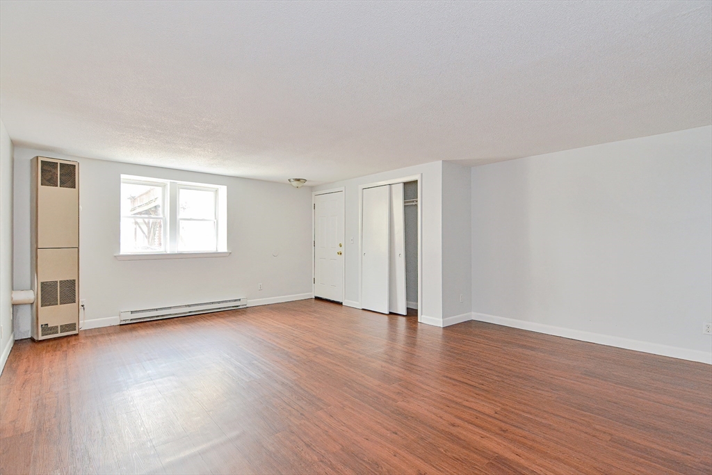 2-6 North Main Street Rochester, NH 03867 - Photo 24 of 40 an empty room with wooden floor and windows