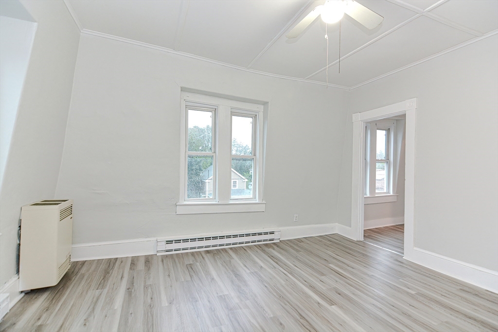 2-6 North Main Street Rochester, NH 03867 - Photo 25 of 40 an empty room with wooden floor and windows