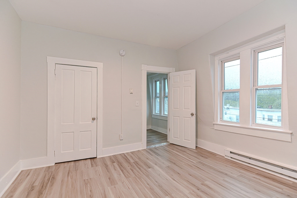 2-6 North Main Street Rochester, NH 03867 - Photo 26 of 40 an empty room with wooden floor and windows