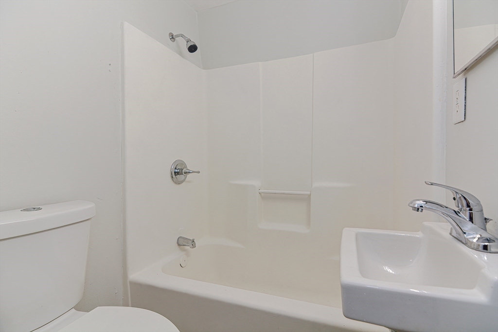 2-6 North Main Street Rochester, NH 03867 - Photo 27 of 40 a bathroom with a sink and toilet